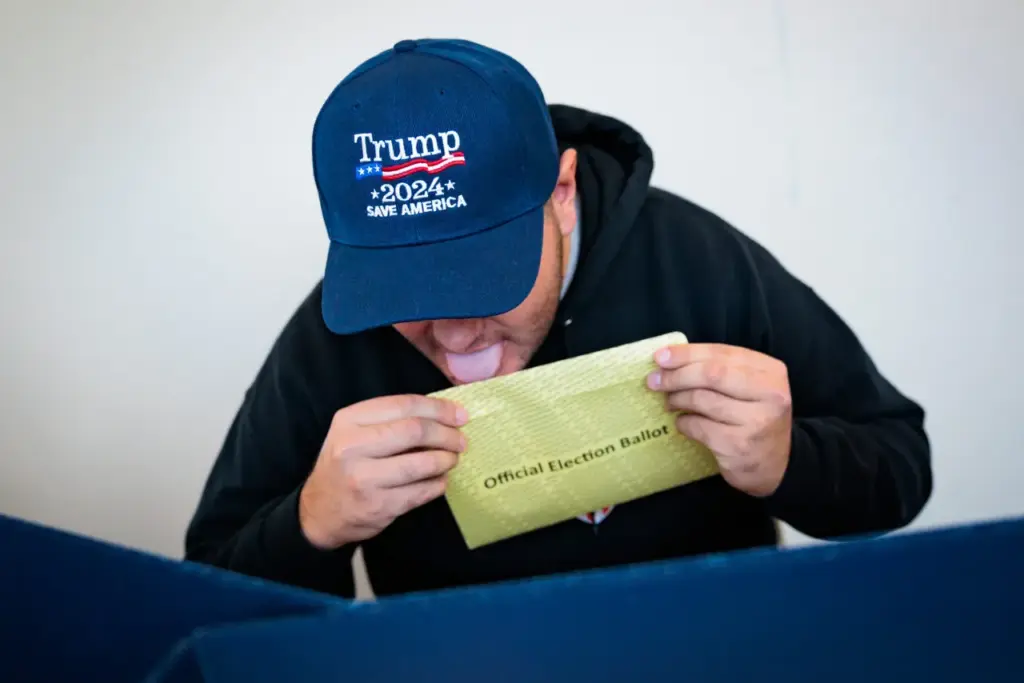 DOYLESTOWN, PENNSYLVANIA - OCTOBER 15: Kenny Laureno, 24, seals their official election ballot while voting