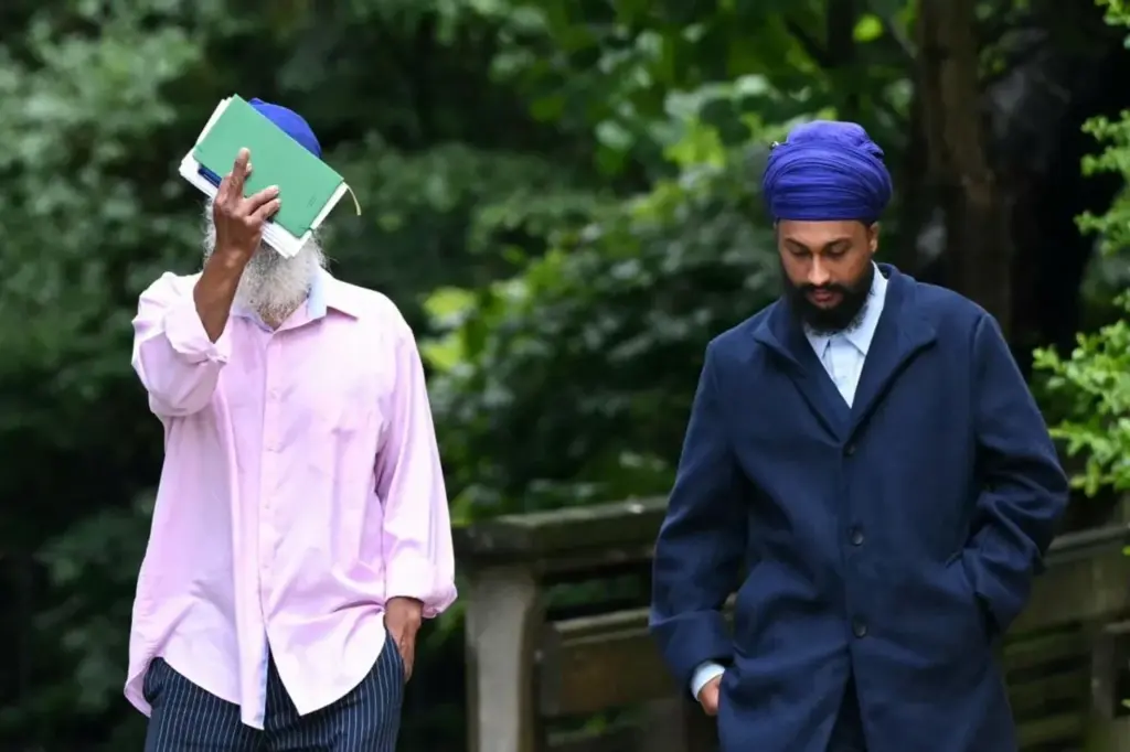 Moga Singh (L), the father of Vickrum Digwa who was on June 1 found guilty of killing 18-year-old student Henry Nowak, and Vickrum's brother Gurpreet Digwa (R) arrive at the Courts of Justice to face charges of possession of offensive weapons, in Southampton, southern England, on June 2, 2026. Body camera footage of a dying student Henry Nowak, who was handcuffed by British police after being stabbed by Vickrum Digwa and falsely accused of racially abusing his murderer, sparked anger on June 2 over police diversity policies. (Photo by JUSTIN TALLIS / AFP via Getty Images)