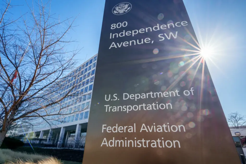 The sun flares next to the sign marking the location of the Federal Aviation Administration (FAA) headquarters on February 9, 2024, in Washington, DC. (Photo by J. David Ake/Getty Images)