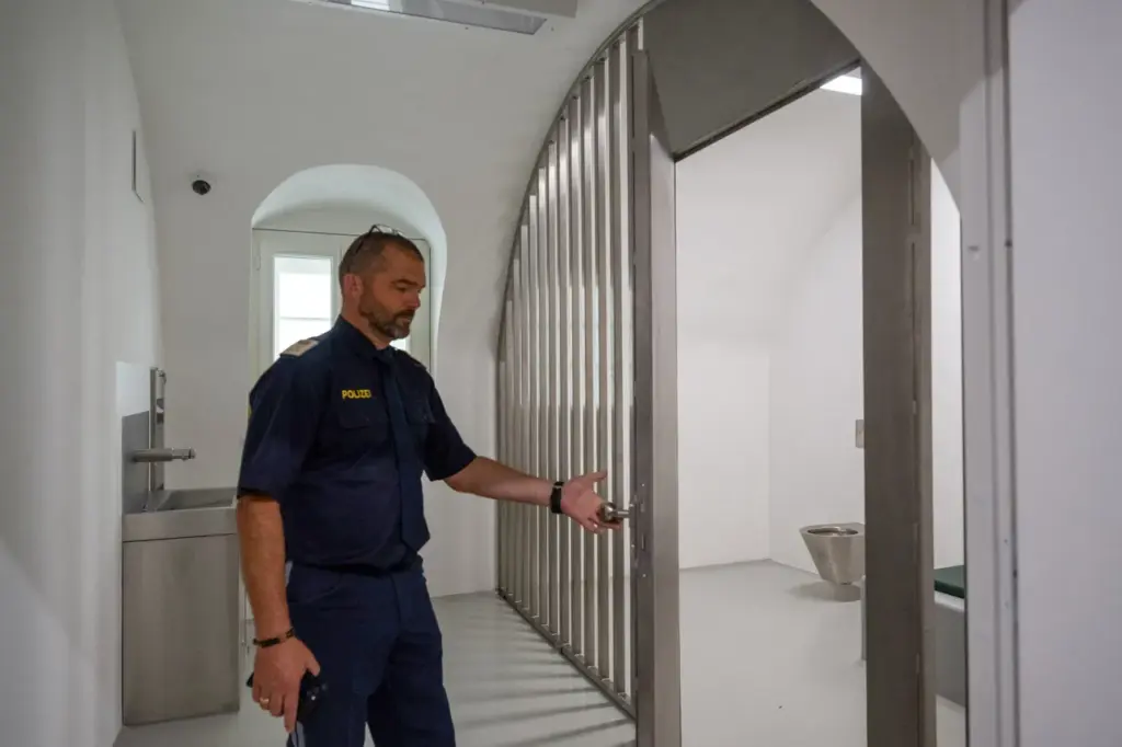 Picture taken on July 16, 2026 shows police chief Inspector Kurt Reiter opening a prison cell inside the listed building of the birth house of former German dictator Adolf Hitler that is turned into a police station, in Braunau am Inn, Austria. (Photo by KERSTIN JOENSSON / AFP via Getty Images)