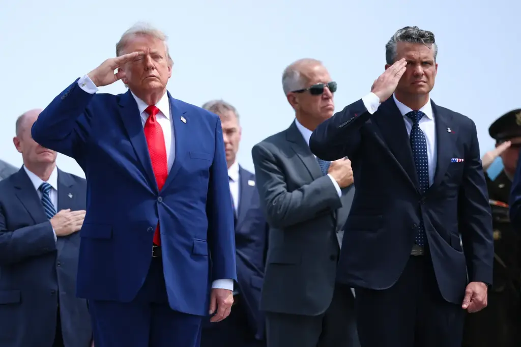 U.S. President Donald Trump (L) and U.S. Secretary of War Pete Hegseth salute during a dignified transfer at Dover Air Force Base July 22, 2026 in Dover, Delaware. (Photo by Kevin Dietsch/Getty Images)