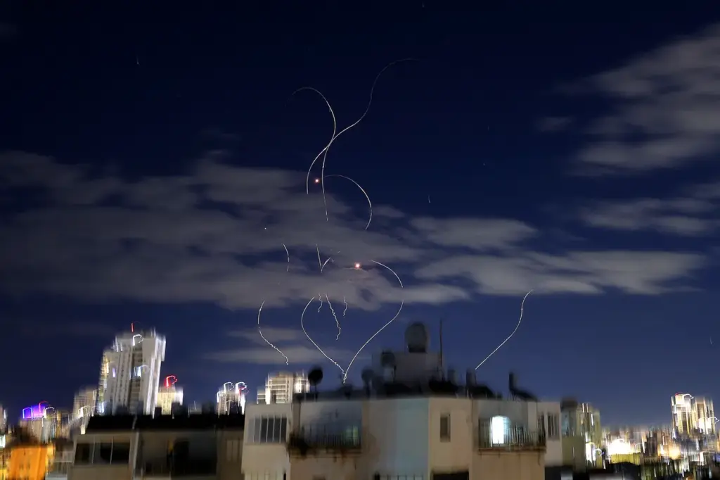 Rocket trails are seen in the sky above the Israeli center coastal city of Netanya amid a fresh barrage of Iranian missile attacks on March 9, 2026. Israel announced a new wave of