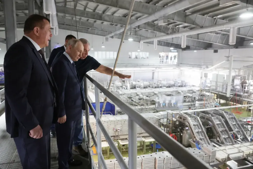 In this pool photograph distributed by the Russian state agency Sputnik, Russia's President Vladimir Putin visits the Yasny fish processing factory on Iturup island, one of four islands in the contested chain known as the Kuril Islands in Russia and the Northern Territories in Japan, on August 13, 2026. (Photo by Gavriil Grigorov / POOL / AFP via Getty Images)