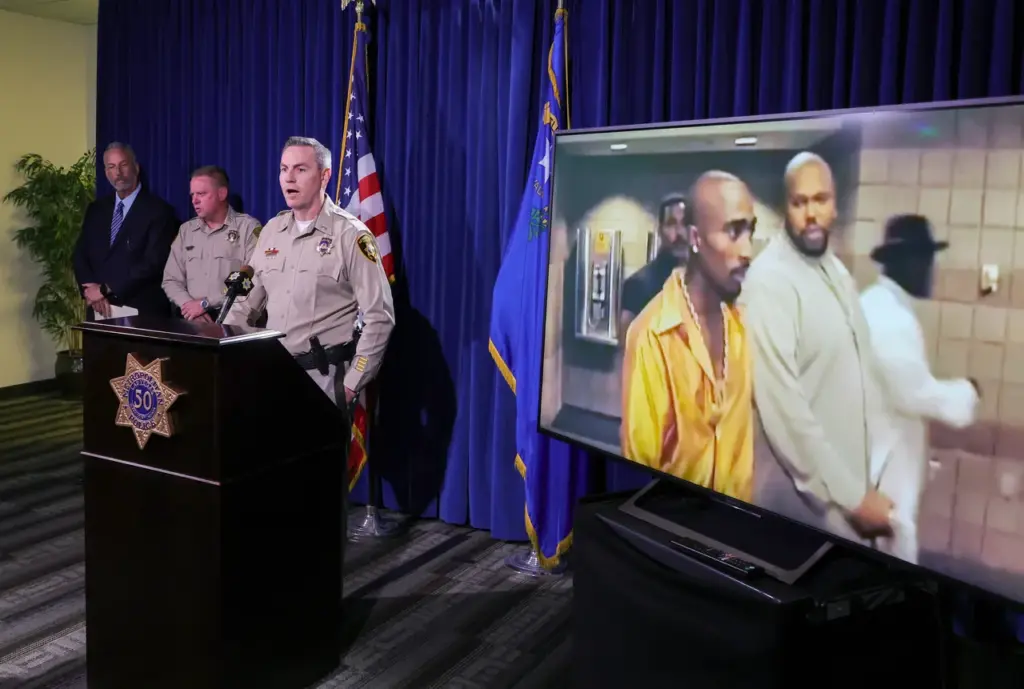 LAS VEGAS, NEVADA - SEPTEMBER 29: An image on a television monitor shows Tupac Shakur (L) and Marion