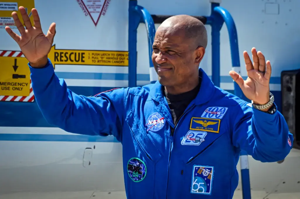 NASA astronaut and Artemis II pilot Victor Glover waves to the crowd during a welcome ceremony ahead of the Artemis II April 1 launch at Kennedy Space Center in Florida on March 27, 2026. (Photo by Miguel J. Rodriguez CARRILLO / AFP via Getty Images)