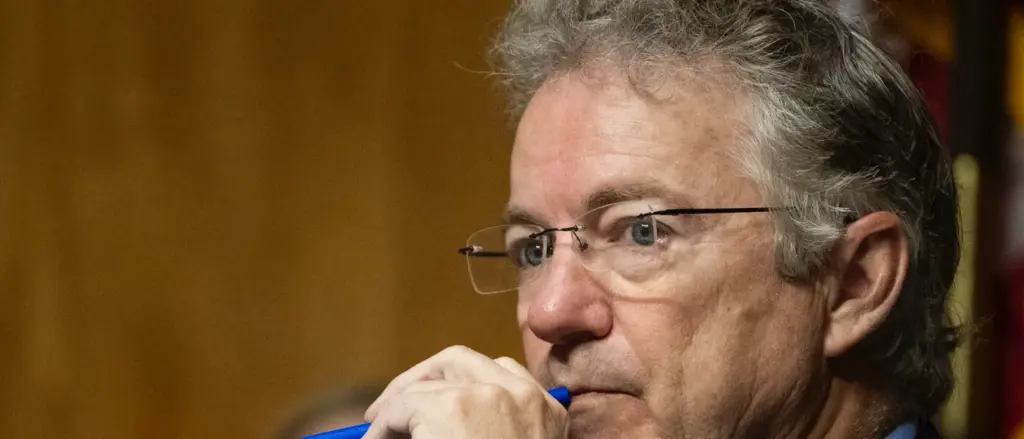 Committee chairman US Senator Rand Paul, Republican from Kentucky, listens as James Erdman III, senior operations officer at the CIA, testifies during a Senate Homeland Security and Governmental Affairs Committee hearing on Capitol Hill in Washington, DC, on May 13, 2026. Erdman testified that he believes there was an effort within the Intelligence Community to downplay the possibility that the COVID-19 pandemic originated in a